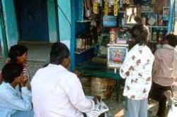 The community is watching TV in a village in India' s Narmada valley