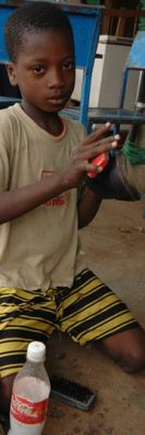 A boy cleans shoes in Burkina Faso. Child labour is a source of income and a symptom of poverty 