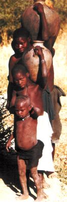 A family carrying water pots in Cameroon